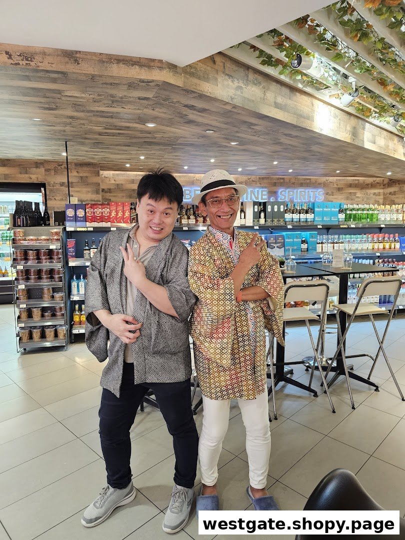 Two smiling individuals pose inside Jays Bar, surrounded by shelves of wine and spirits.