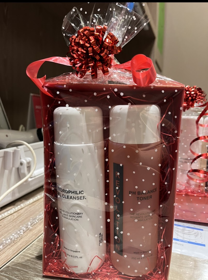 A red gift box containing two skincare products: a hydrophilic gel cleanser and a pH balance toner.