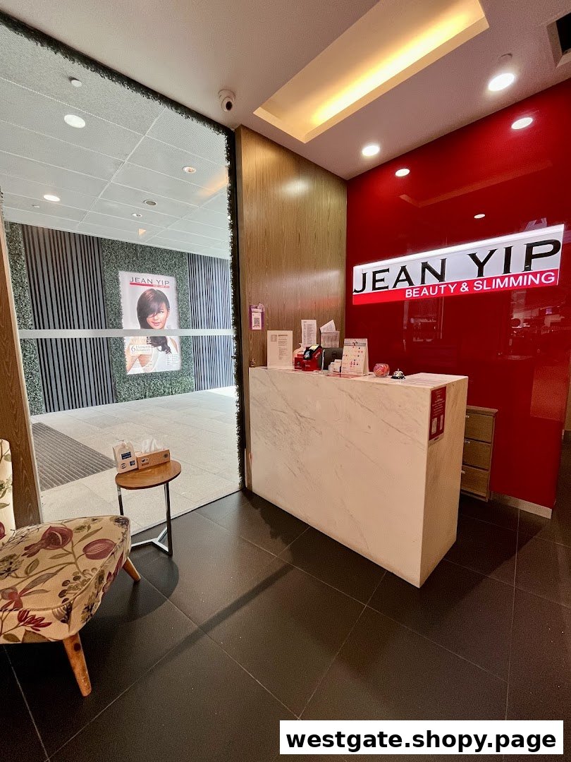 The reception area of Jean Yip Hairdressing and Hairspa, featuring a white counter and red accent wall.
