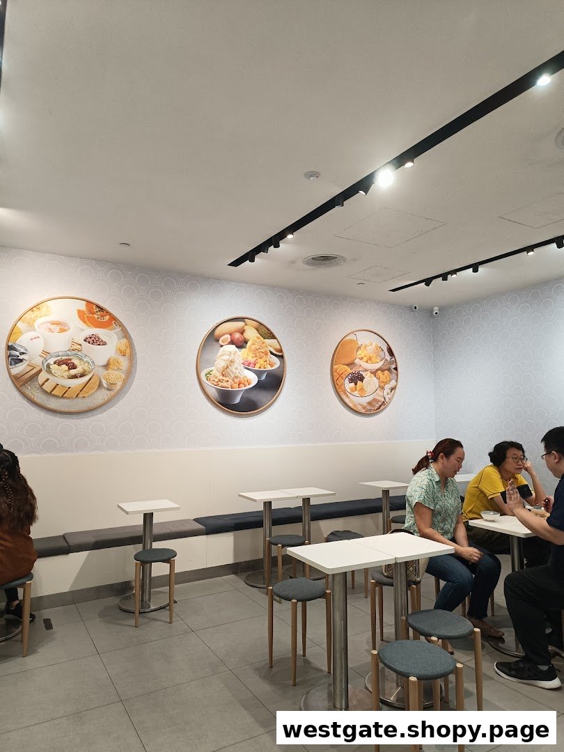 Interior view of Ji De Chi Dessert with customers enjoying treats and decorative food art on the walls.