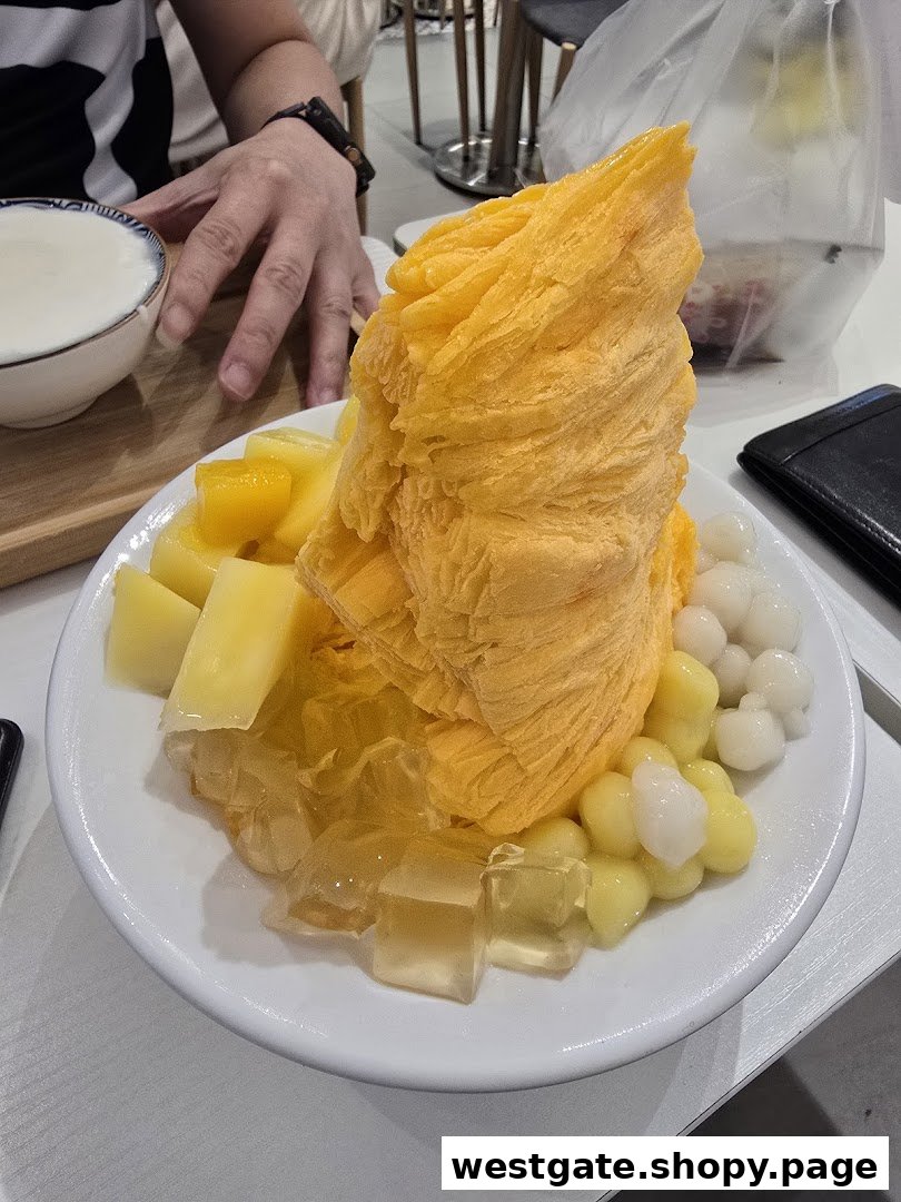 A vibrant mango shaved ice dessert with fresh mango chunks, jelly, and chewy toppings.