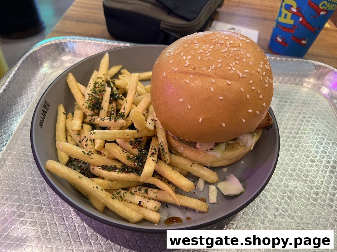 A delicious burger and seasoned fries served on a plate at JINJJA Chicken.