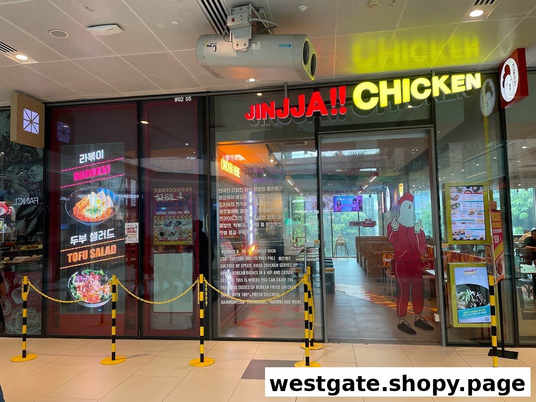 The vibrant storefront of JINJJA Chicken, showcasing its entrance and promotional displays.