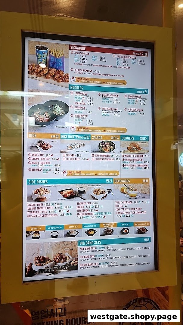 A digital menu board displaying various Korean fried chicken, noodle, rice, and burger dishes.