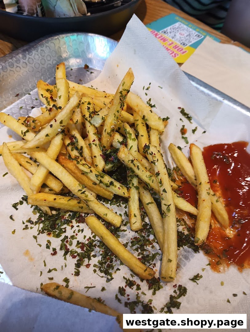 A close-up of golden french fries seasoned with herbs, served with a side of ketchup.