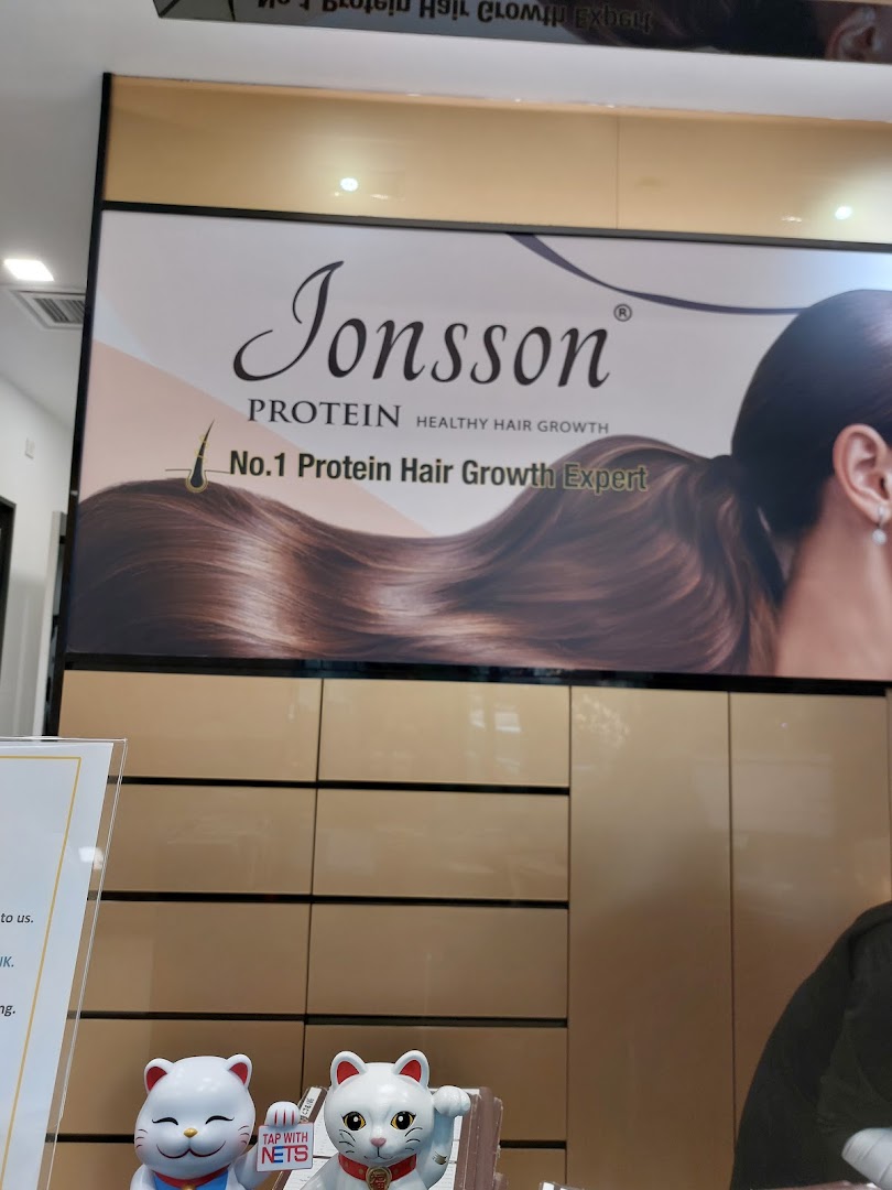 An interior shot featuring a large Jonsson Protein banner promoting healthy hair growth solutions.