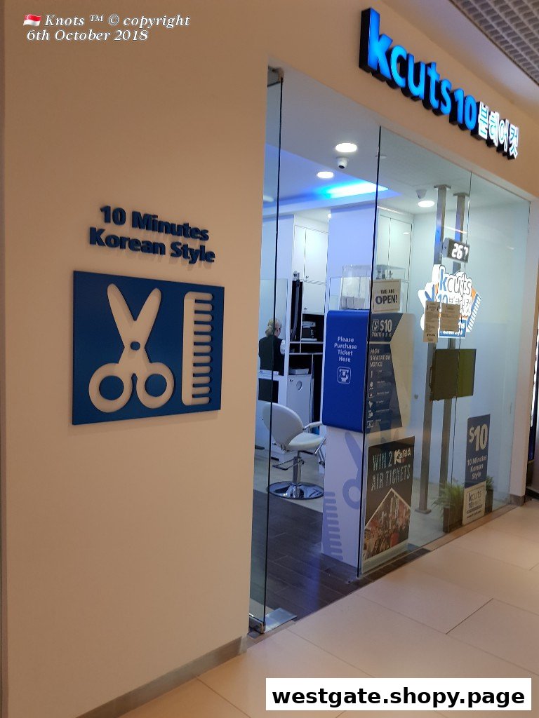 The entrance of kcuts 10, a hair salon, featuring its logo, '10 Minutes Korean Style' sign, and glass doors.