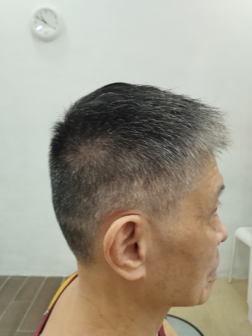 Side profile of a person with a fresh, short haircut, showcasing kcuts' styling.