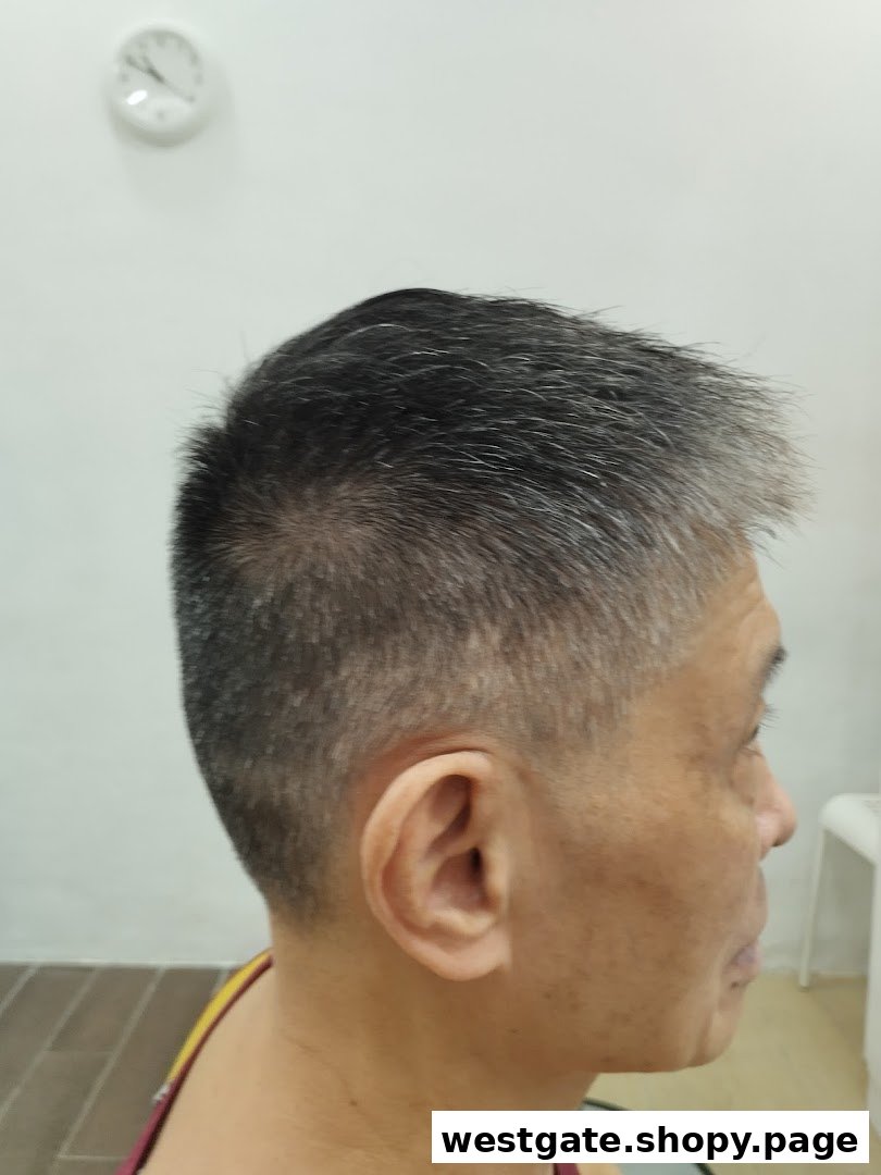 Side profile of a person with a fresh, short haircut, showcasing kcuts' styling.
