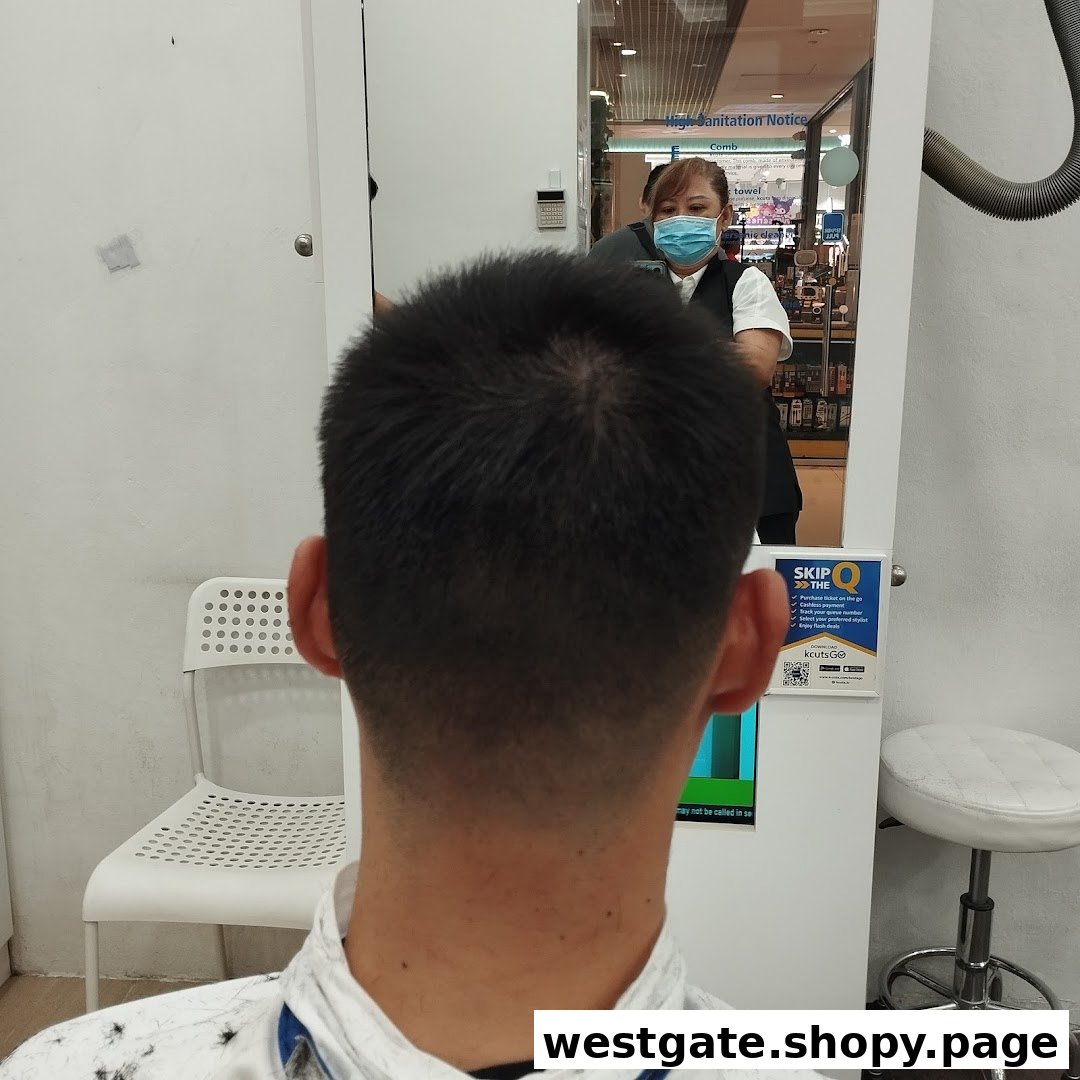 A customer receives a haircut at kcuts, with the stylist reflected in the mirror.
