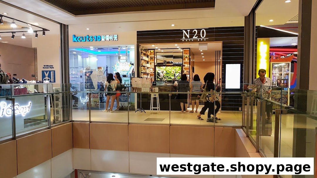 View of kcuts and N20 Nail Spa storefronts inside a bustling shopping mall.