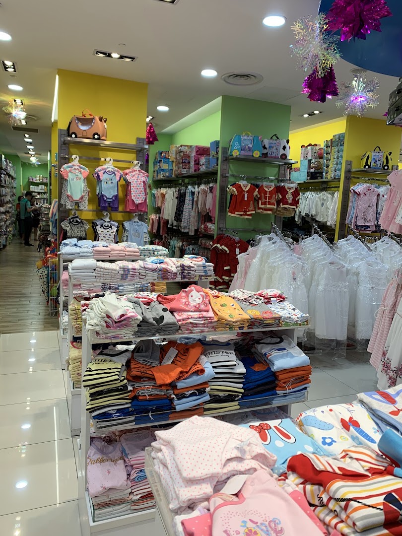 An interior view of Kiddy Palace, showcasing colorful displays of children's clothing and accessories.