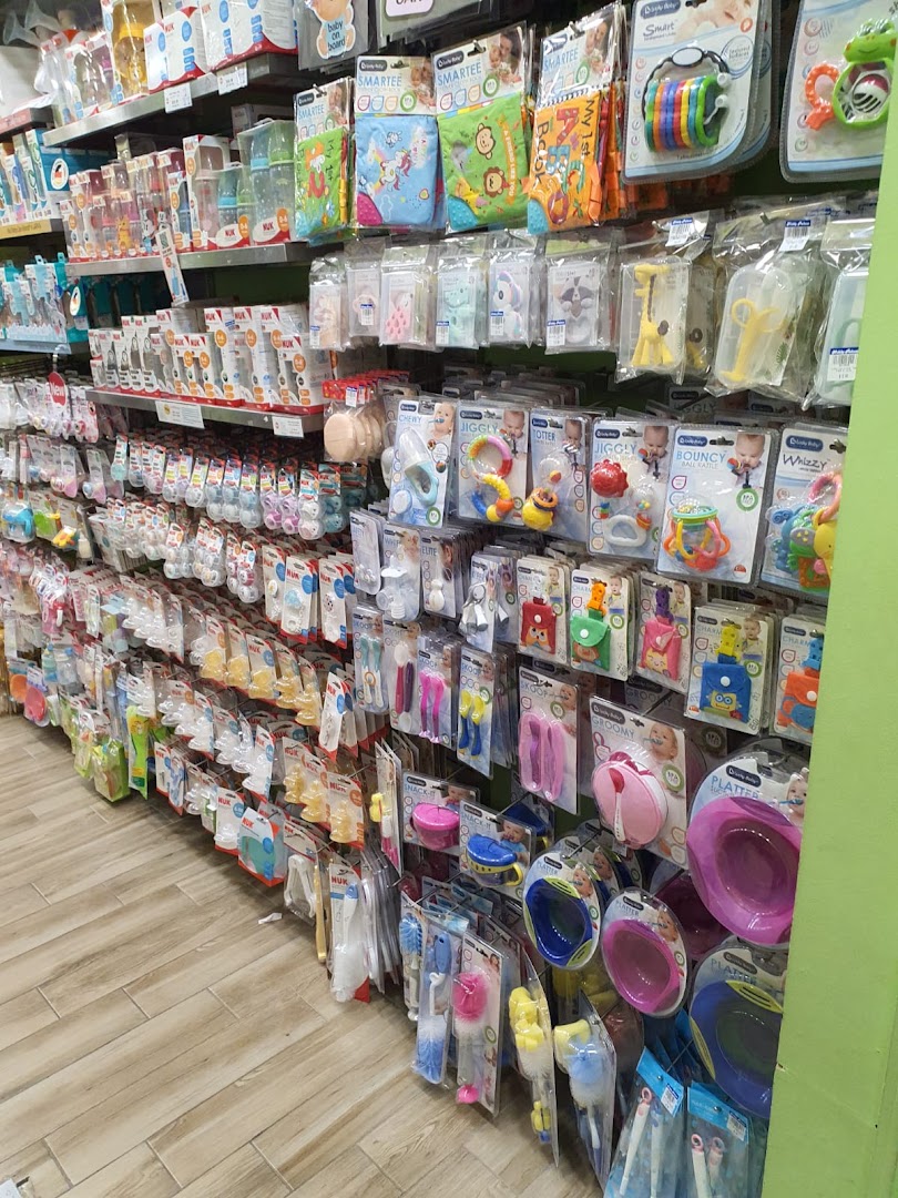 Shelves filled with a wide variety of baby bottles, feeding accessories, and infant toys.