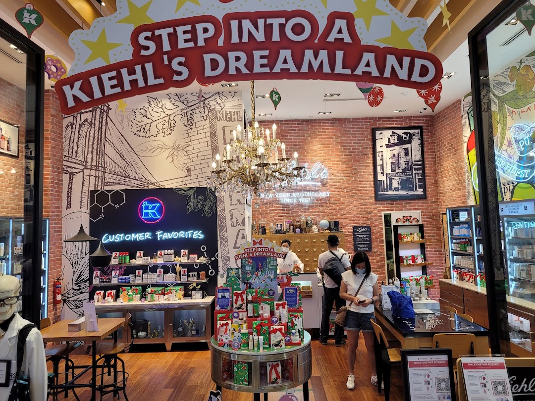 The vibrant interior of Kiehl's Westgate, featuring product displays, customers, and festive 'Dreamland' decor.