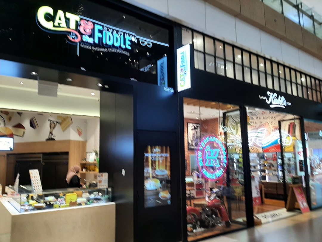 The storefronts of Cat & the Fiddle and Kiehl's, showcasing their entrances and displays.