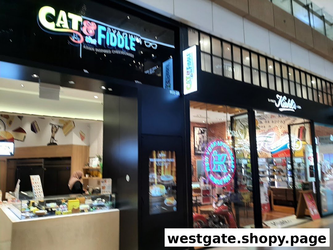 The storefronts of Cat & the Fiddle and Kiehl's, showcasing their entrances and displays.