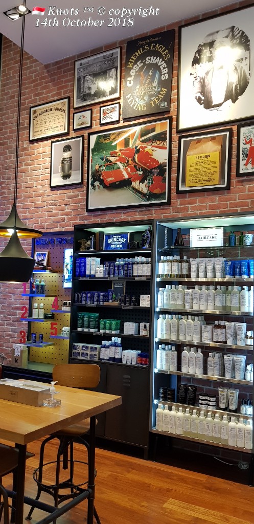 Interior view of Kiehl's store, showcasing skincare and haircare products on shelves, with vintage decor and a wooden table.