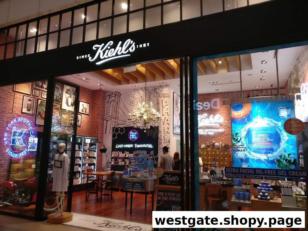 The illuminated storefront of Kiehl's at Westgate, showcasing its distinctive apothecary aesthetic and product displays.