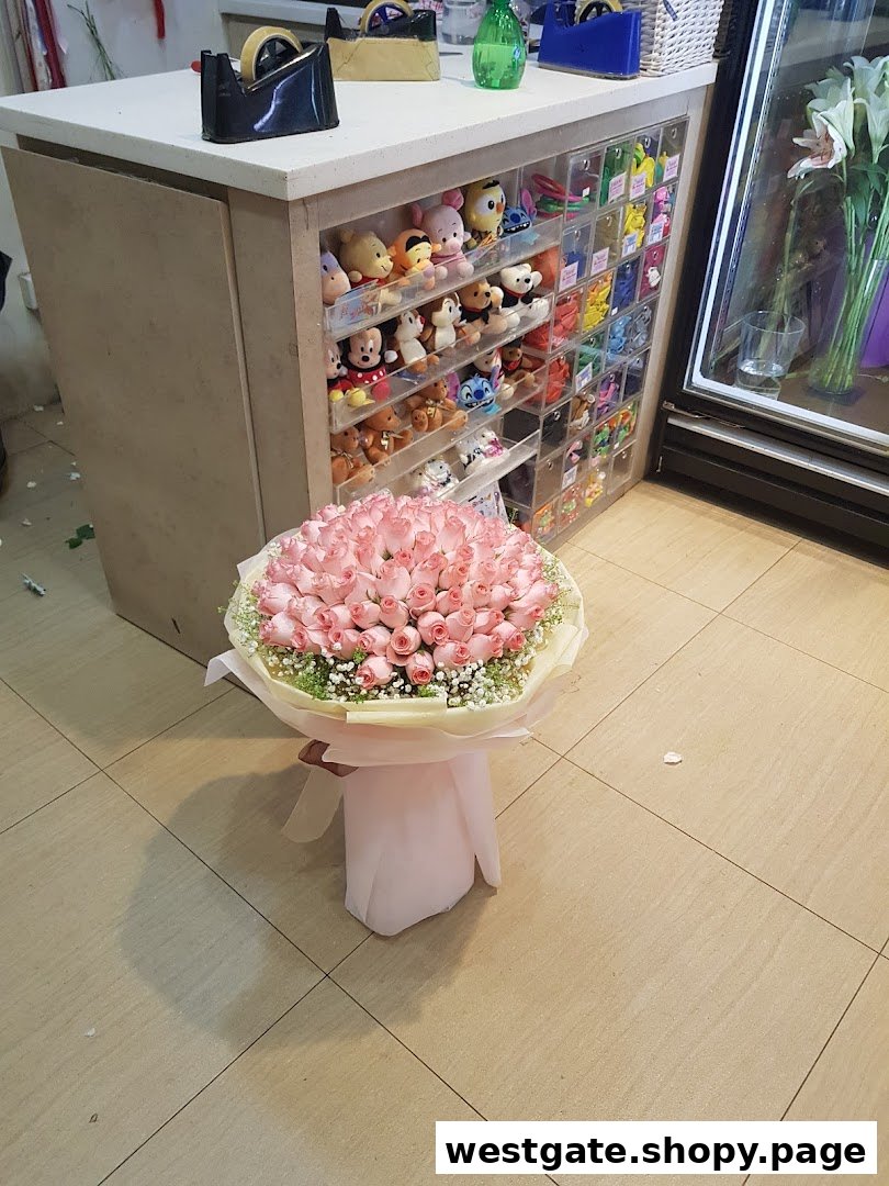 A large bouquet of pink roses in the foreground, with a display of plush toys and gifts in a flower shop.