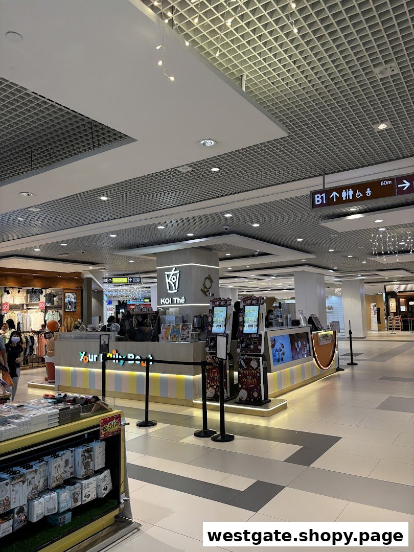 A vibrant KOI Thé bubble tea kiosk with colorful counter design inside Westgate Mall.