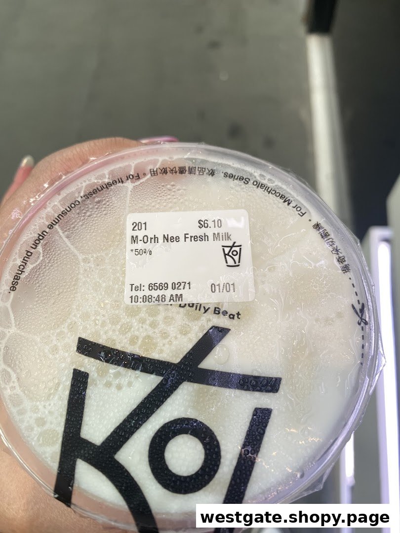 A close-up of a KOI Thé bubble tea cup with a label showing 'M-Orh Nee Fresh Milk'.