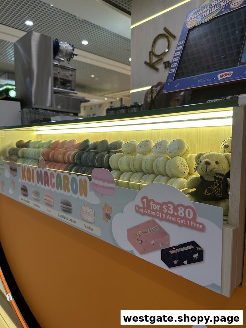 A vibrant display of colorful macarons with a promotional offer at KOI Thé.