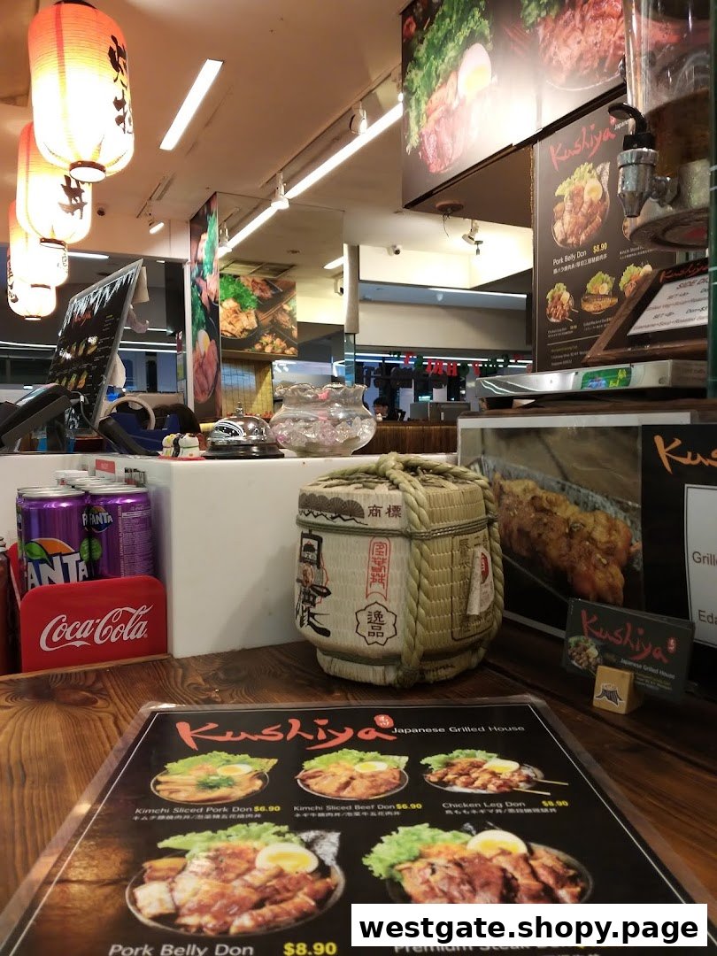 A close-up view of Kushiya Japanese Grill House's counter, featuring a menu, Japanese decor, and beverages.
