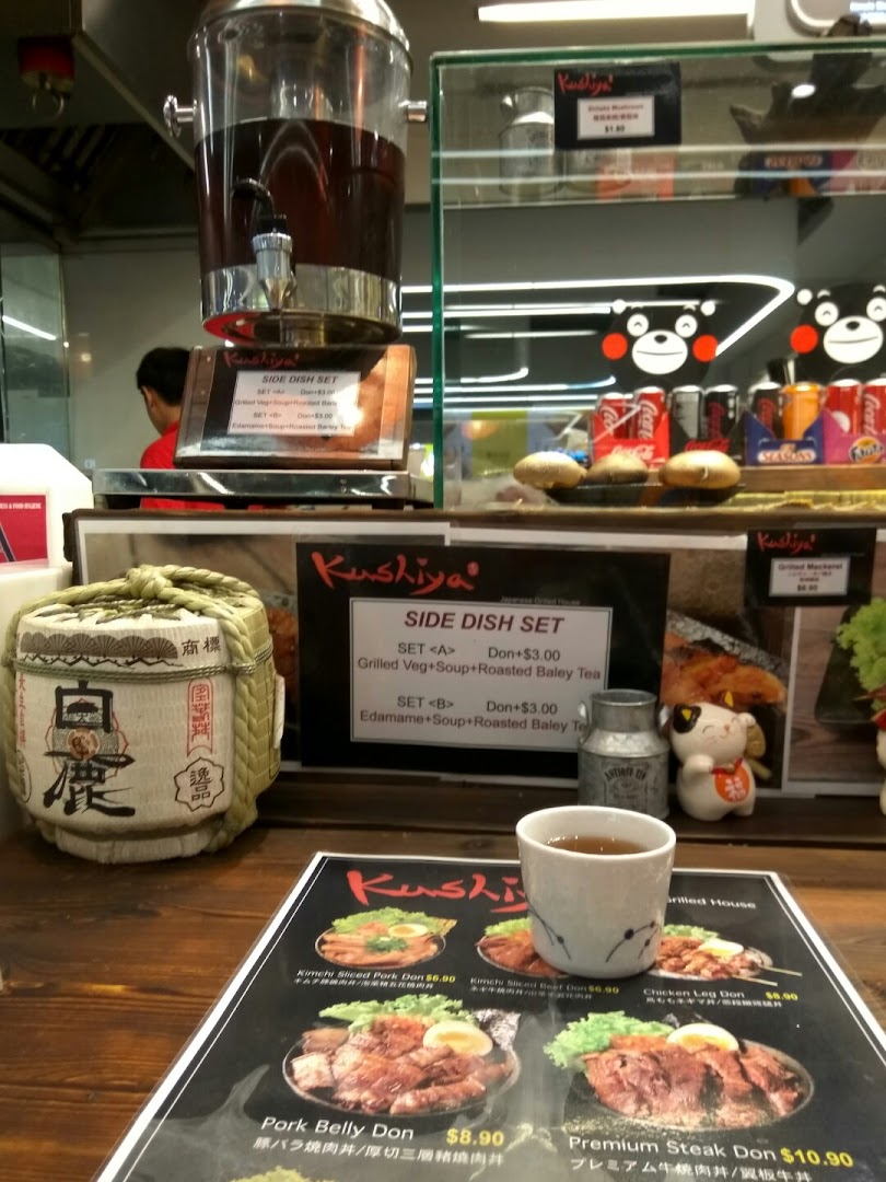 A close-up of Kushiya Japanese Grill House's menu, featuring various donburi and side dish options.