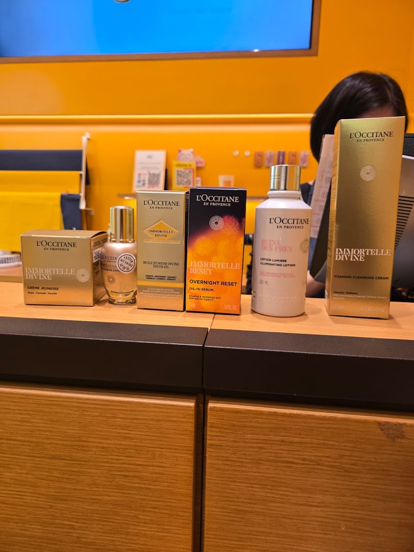 A selection of L'Occitane skincare products, including Immortelle Divine and Overnight Reset lines, displayed on a counter.