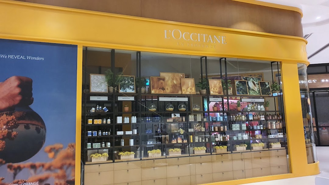 The L'OCCITANE shop front with its distinctive yellow facade and product displays.