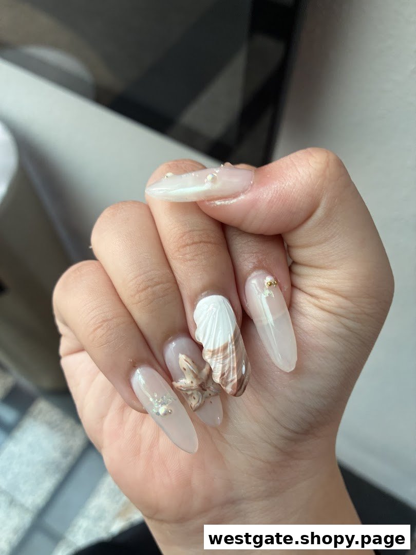 A hand showcasing elegant long nails with intricate seashell and starfish 3D designs.