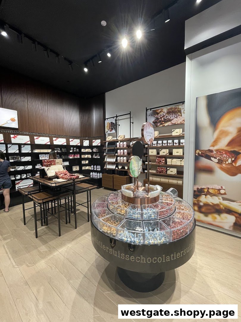 Interior view of a Läderach chocolate shop, featuring diverse chocolate displays and a customer browsing.