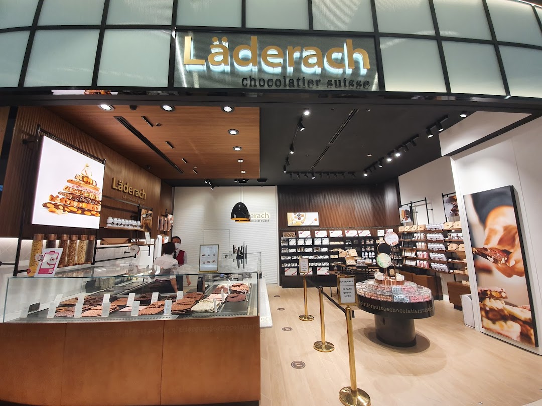 Interior view of Läderach chocolate shop showcasing fresh chocolate displays and retail products.