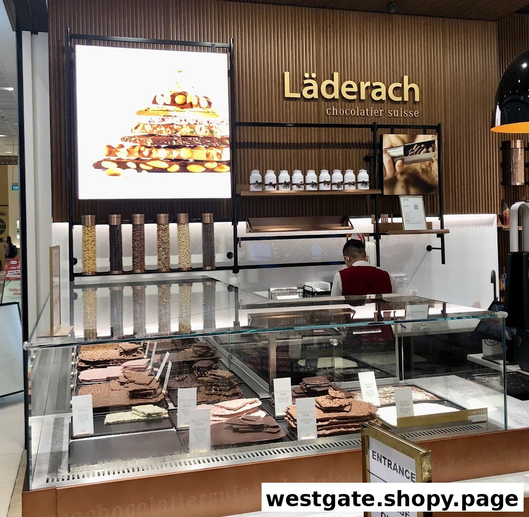 Interior view of a Läderach chocolate shop featuring a display of fresh chocolates.