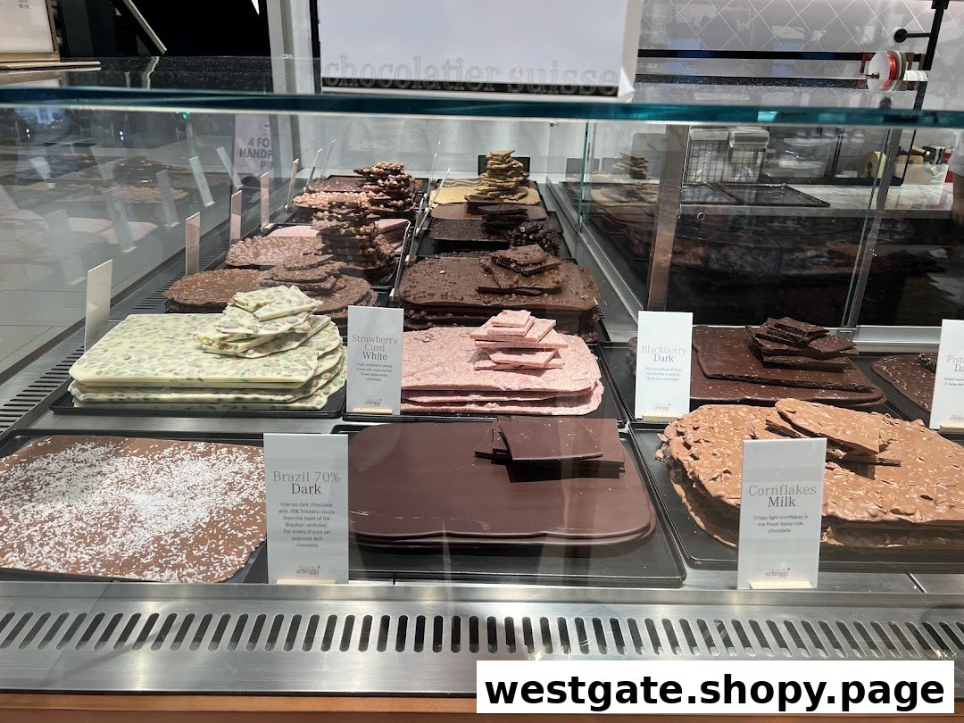 A vibrant display case showcasing various artisanal chocolate slabs and bark at Läderach.