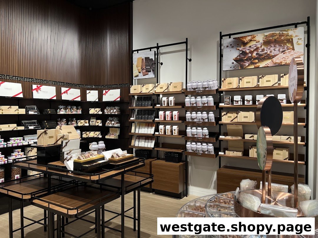Interior view of Läderach chocolate shop showcasing shelves filled with various chocolate products and gift boxes.