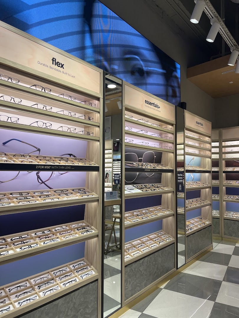 Interior view of Lenskart showcasing numerous eyeglasses on well-lit display shelves.