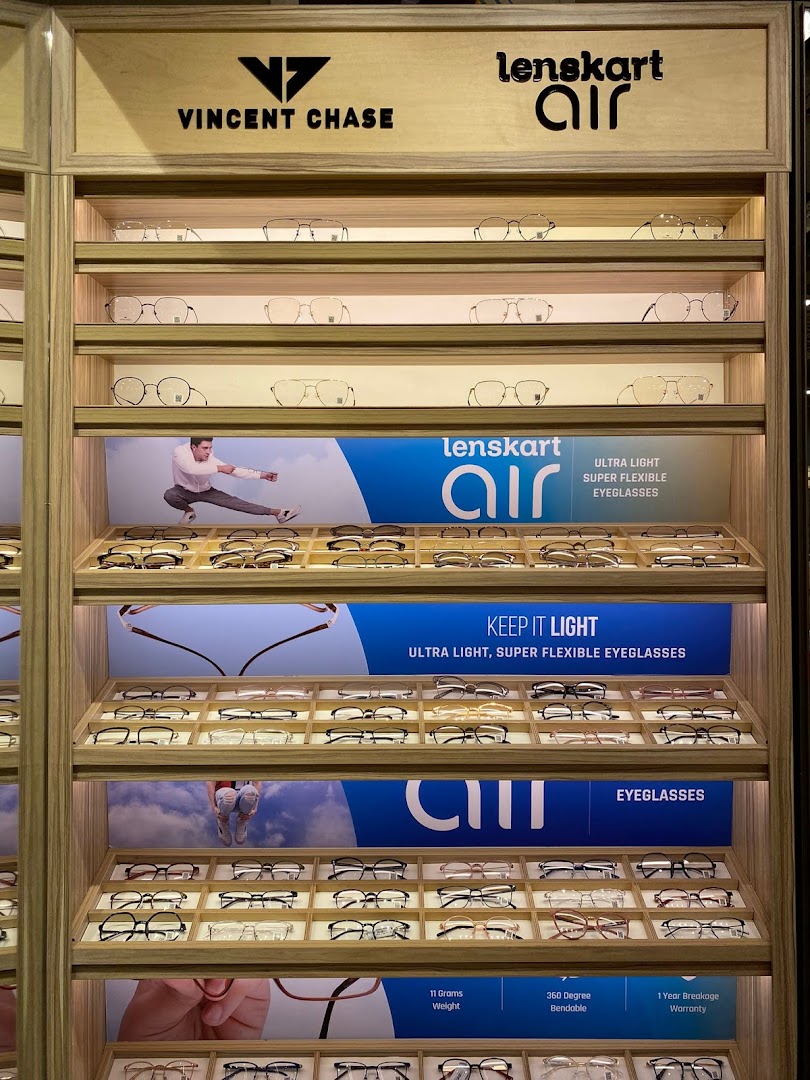 A well-lit display showcasing various eyeglasses and frames from Lenskart and Vincent Chase brands.