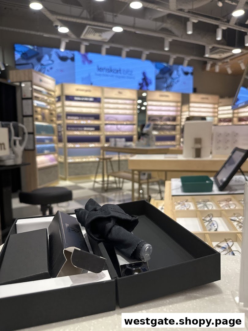 Interior view of Lenskart showcasing eyewear displays, a large digital screen, and a product box on the counter.