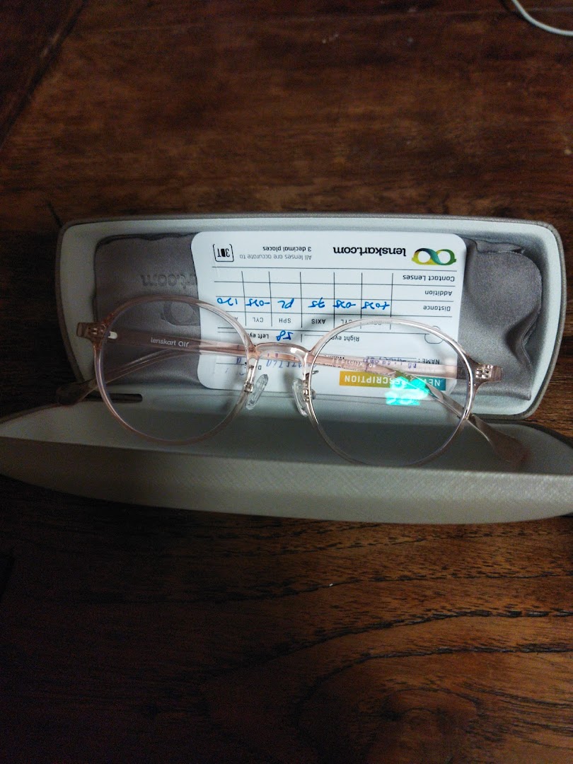 A pair of Lenskart eyeglasses in their case with a prescription card.