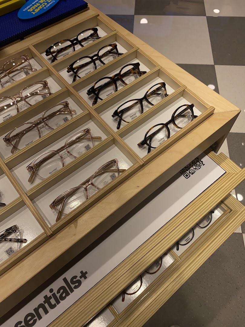 A close-up view of various eyeglasses displayed neatly in wooden trays at Lenskart.