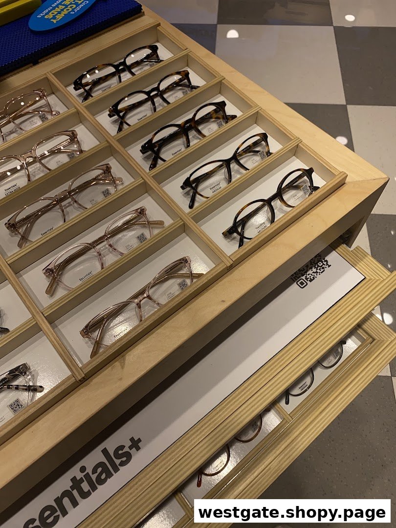 A close-up view of various eyeglasses displayed neatly in wooden trays at Lenskart.
