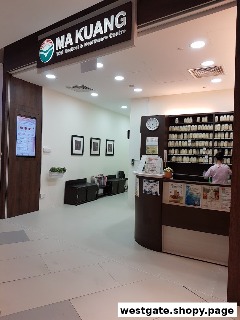 The clean, well-lit interior of Ma Kuang TCM Clinic, featuring a reception desk, waiting area, and traditional medicine shelves.