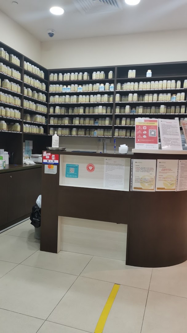 Interior view of Ma Kuang TCM Clinic, featuring a reception counter and shelves stocked with traditional medicine bottles.