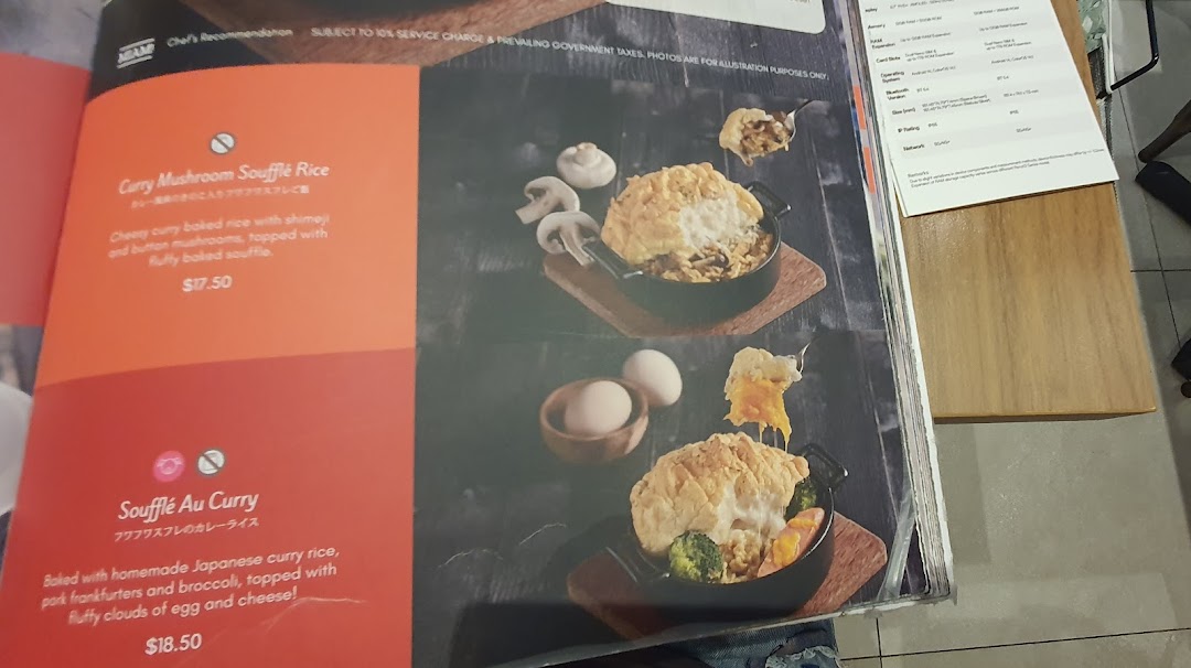 A close-up view of a menu page featuring two soufflé rice dishes with descriptions and prices.
