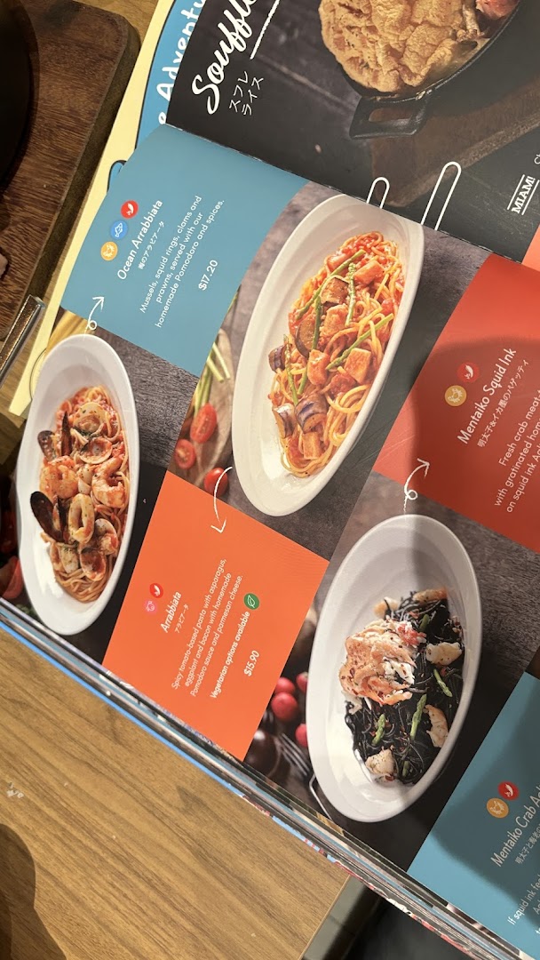 A close-up view of a menu page featuring various pasta dishes with vibrant photos and descriptions.