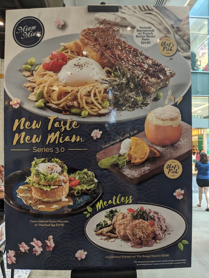 A promotional menu board for Miam Miam showcasing new French-Japanese fusion dishes and desserts.