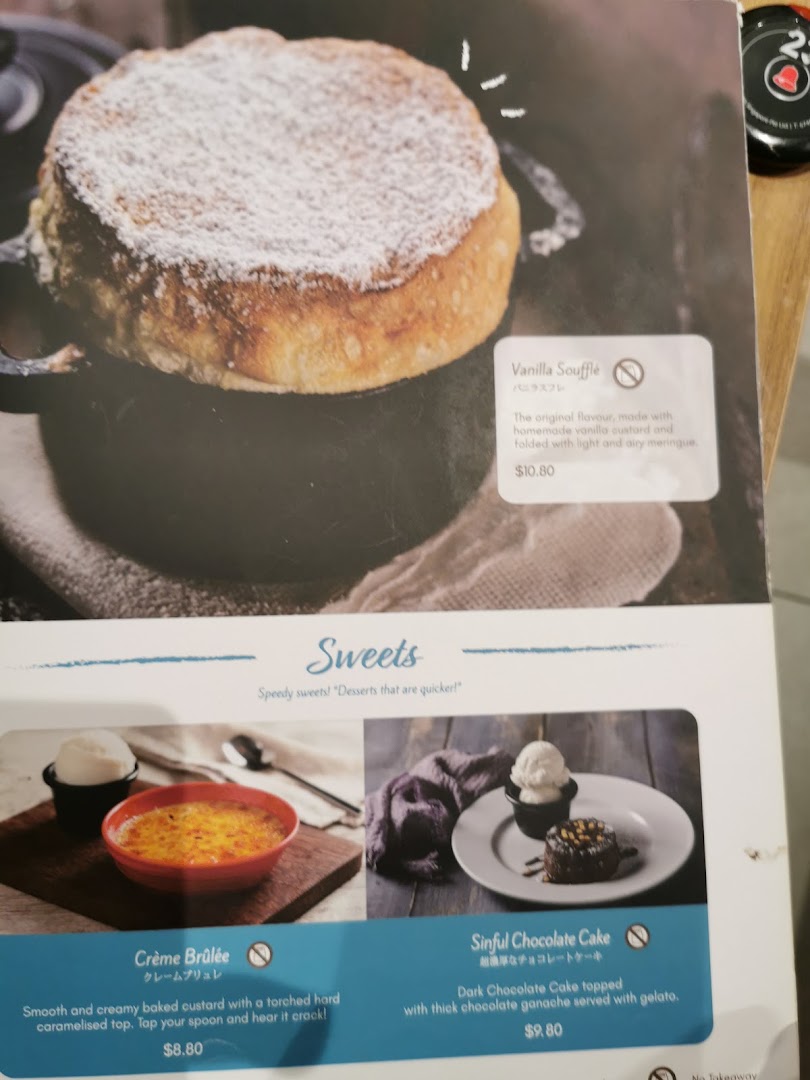 A menu page showcasing delicious dessert options including soufflé, crème brûlée, and chocolate cake.