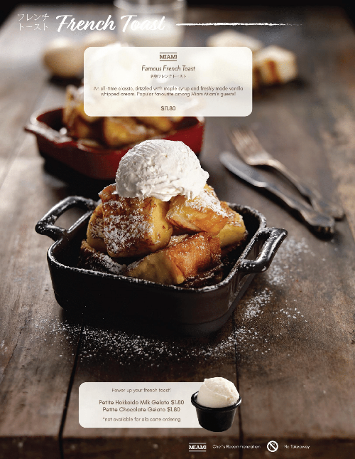 A close-up of Miam Miam's Famous French Toast topped with vanilla ice cream and powdered sugar.