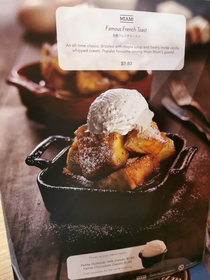 A delicious plate of Famous French Toast with vanilla ice cream and powdered sugar from Miam Miam's menu.